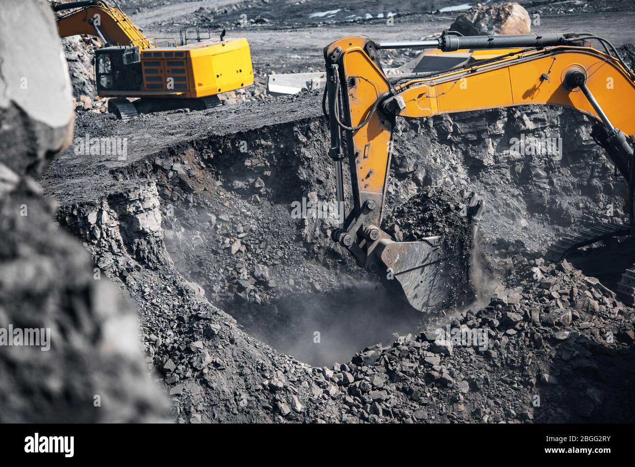 Excavator work loading of coal into Yellow mining truck. Open pit mine ...