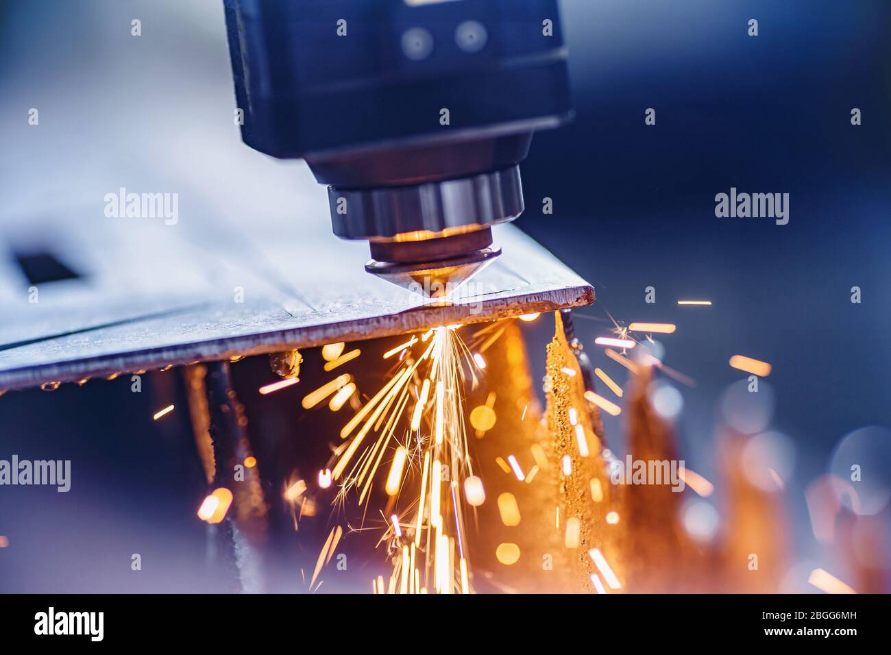 CNC laser machine cutting sheet metal with light spark. Technology plasma industrial, Blue steel