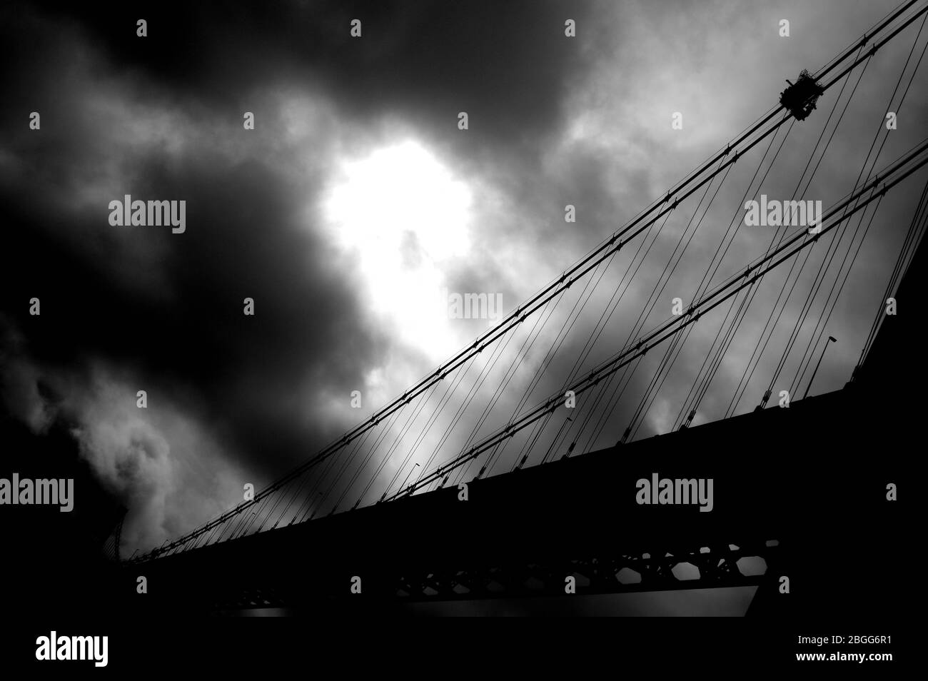 Large suspension bridge spanning a wide river Stock Photo - Alamy