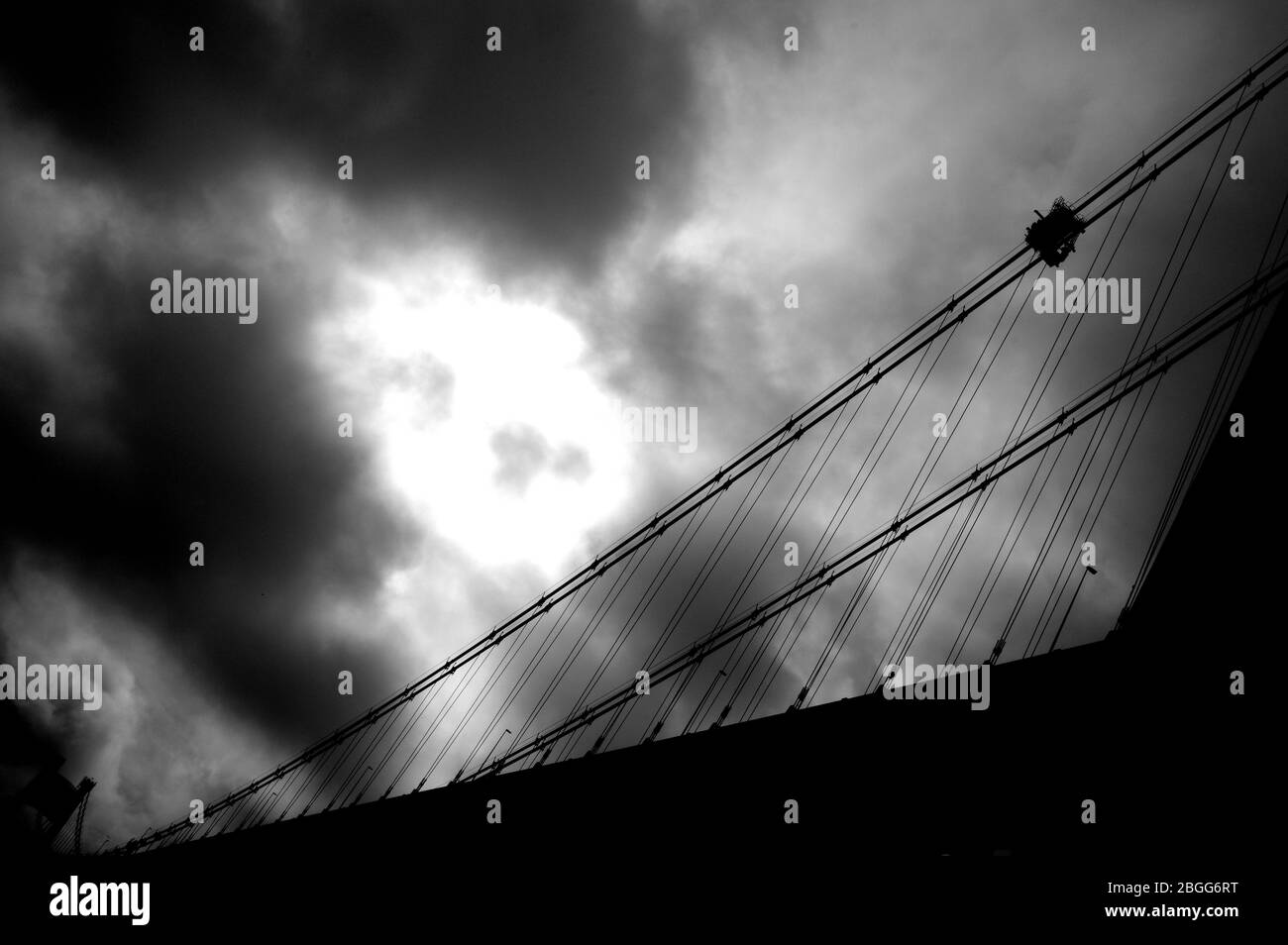 Large suspension bridge spanning a wide river Stock Photo - Alamy