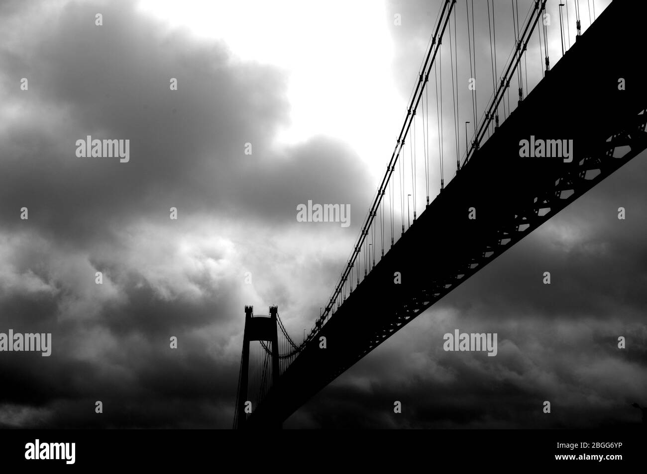 Large suspension bridge spanning a wide river Stock Photo - Alamy