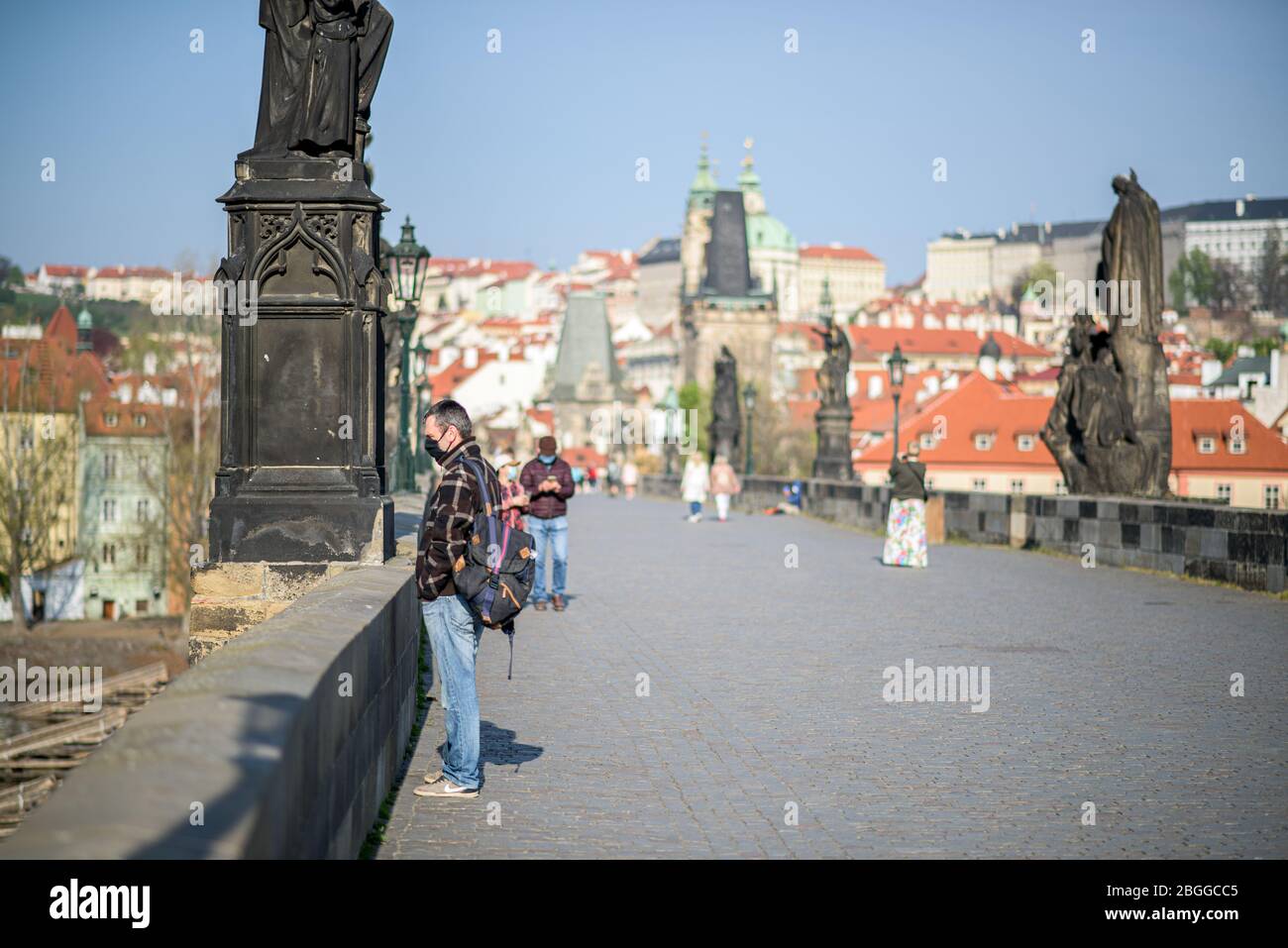 People on the Charles Bridge in Prague during quarantine Stock Photo
