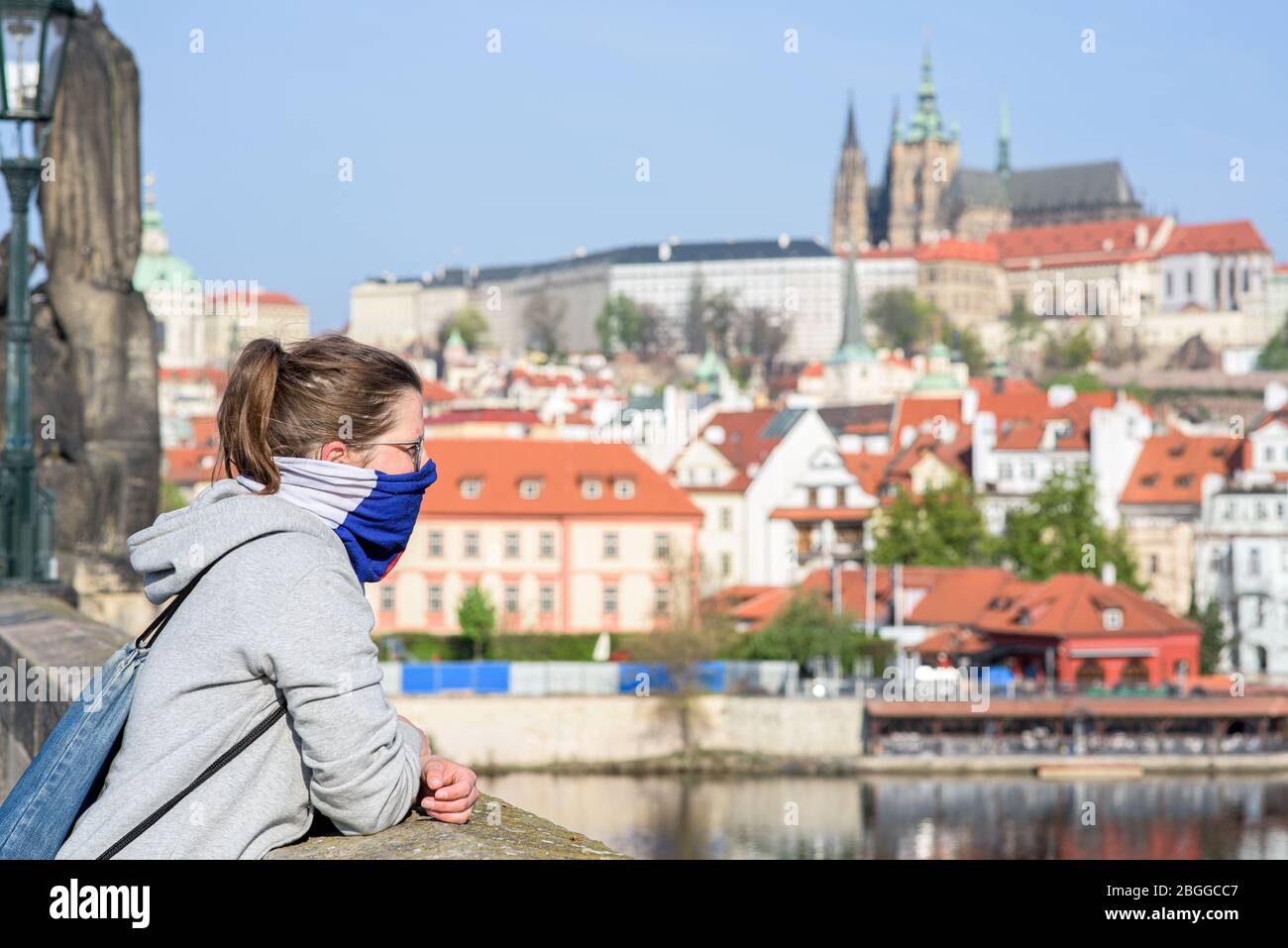 Woman, looking at the distance from Charles Bridge during quarantine Stock Photo