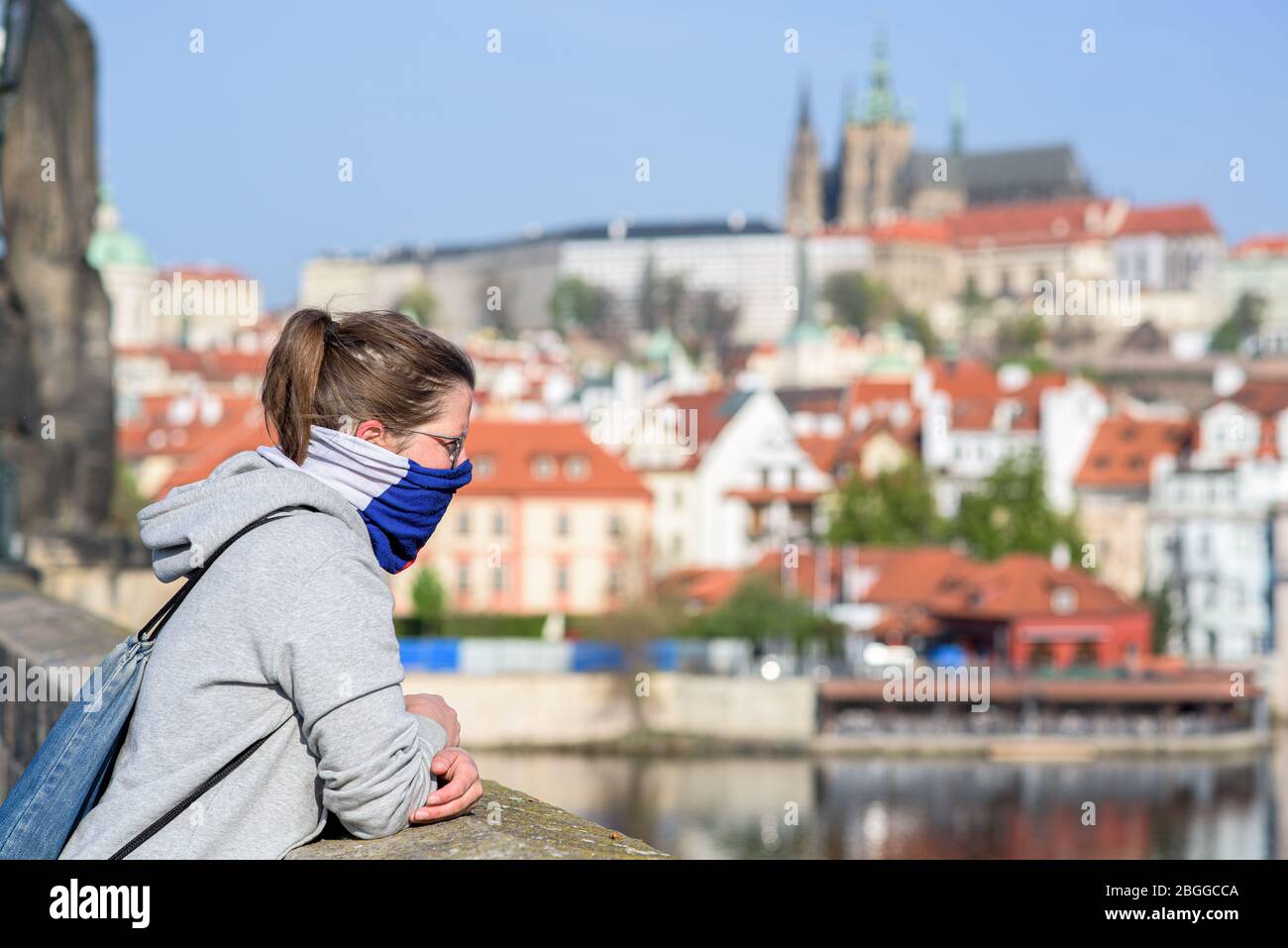 Woman, looking at the distance from Charles Bridge during quarantine Stock Photo
