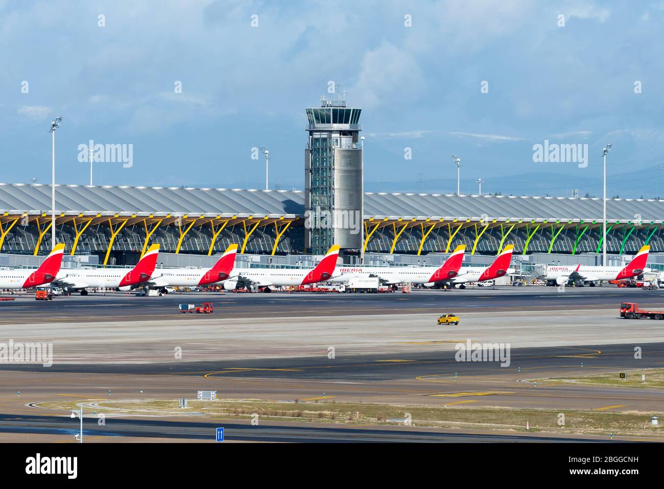 Multiple Iberia Airlines Airbus aircraft lined up Barajas Airport (LEMD) Terminal 4. Busy travel period in airline hub. Aircraft parked. Stock Photo