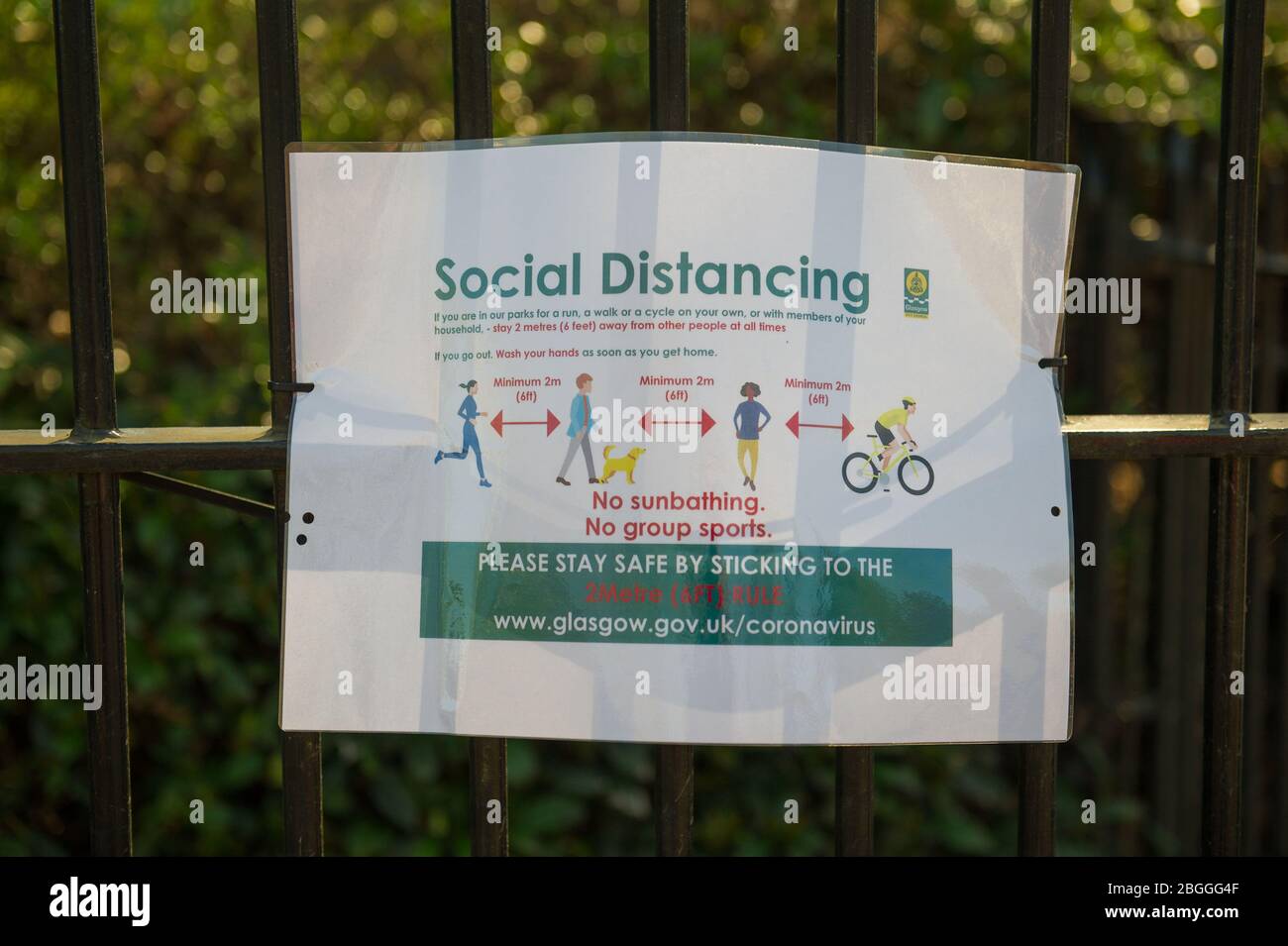 Glasgow, UK. 21st Apr, 2020. Pictured: Sign on park gate advising people on social distancing in the park. Scenes from Kelvingrove Park in Glasgow during the coronavirus (COVID-19) lockdown. Credit: Colin Fisher/Alamy Live News Stock Photo