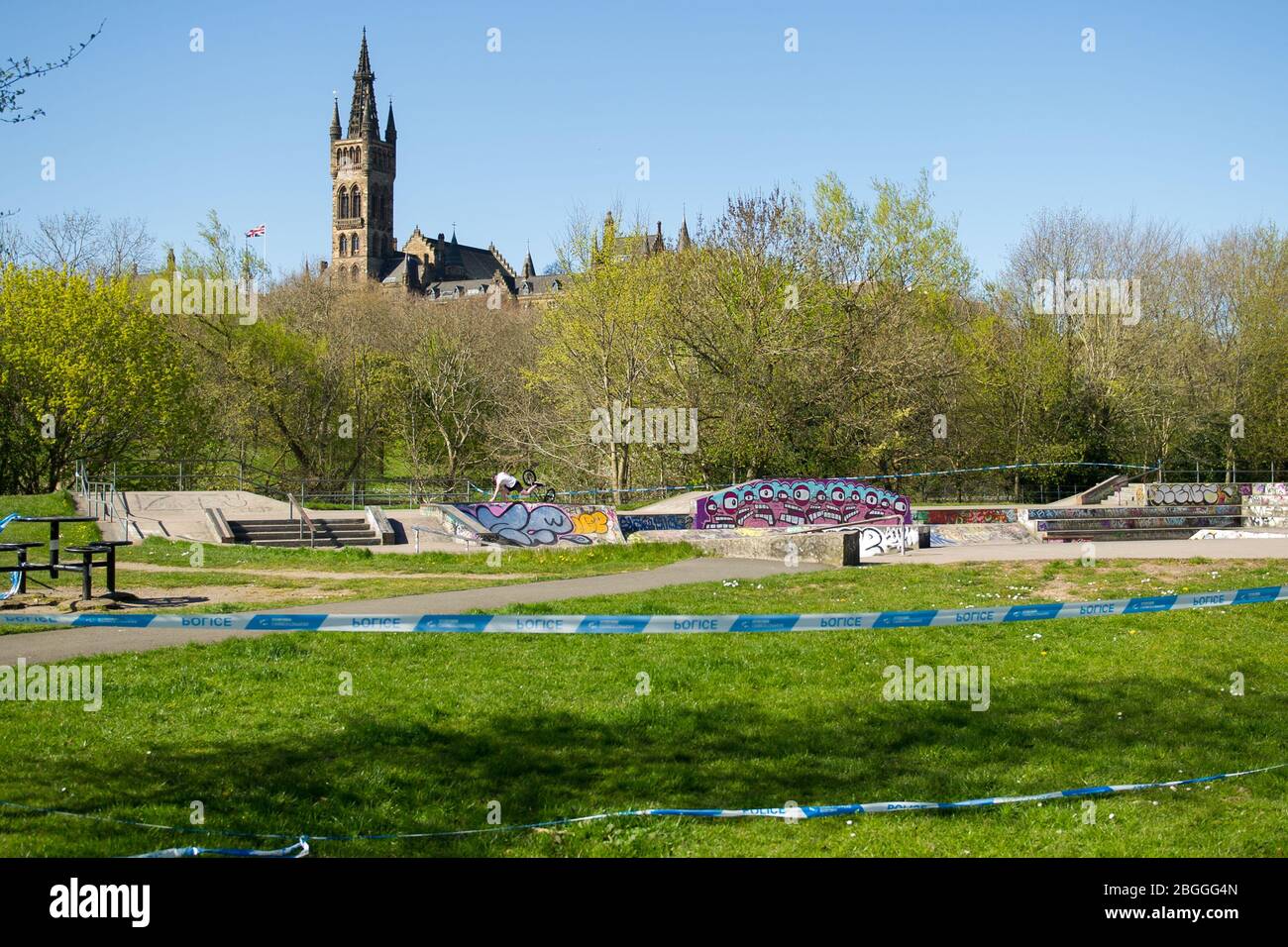 Glasgow, UK. 21st Apr, 2020. Pictured: Empty skate park which has been cordoned off with police tape. Note the biker in the background is crashing his bike. Scenes from Kelvingrove Park in Glasgow during the coronavirus (COVID-19) lockdown. Credit: Colin Fisher/Alamy Live News Stock Photo