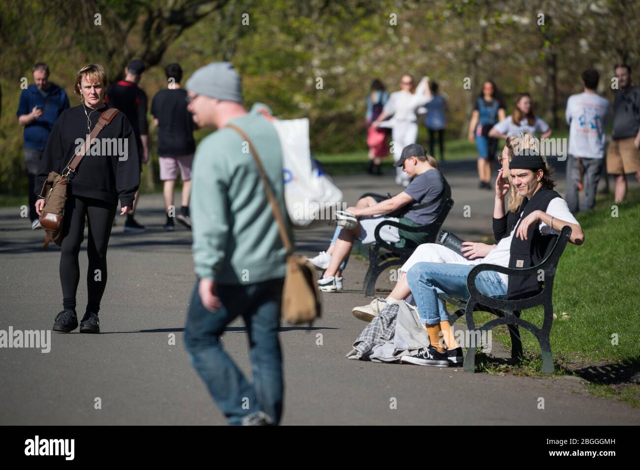 Glasgow, UK. 21st Apr, 2020. Pictured: The park seems quite busy with people as everyone goes out to enjoy the warm sunshine and blue sky. Scenes from Kelvingrove Park in Glasgow during the coronavirus (COVID-19) lockdown. Credit: Colin Fisher/Alamy Live News Stock Photo