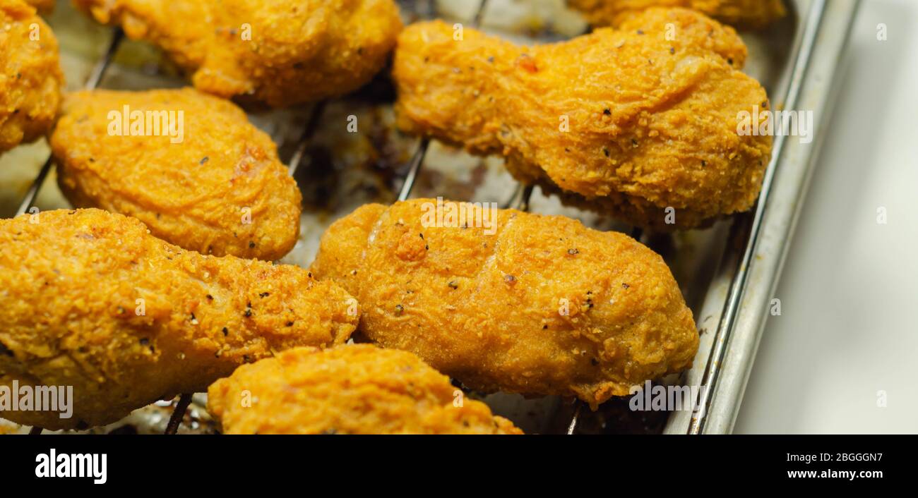 Southern crispy battered fried chicken wings, deepfried chicken wings on the metal tray, fast