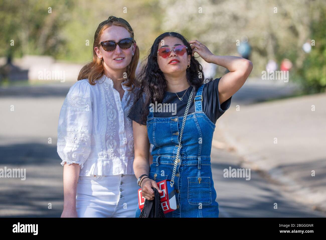 Glasgow, UK. 21st Apr, 2020. Pictured: People dress in summer fashion as they enjoy the warm sunshine and blue skies. Scenes from Kelvingrove Park in Glasgow during the coronavirus (COVID-19) lockdown. Credit: Colin Fisher/Alamy Live News Stock Photo