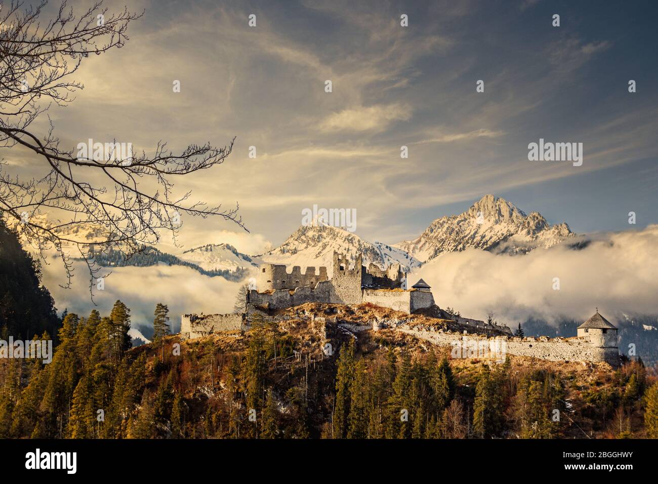 Snowy Rocky Mountains In Clouds With Medieval Castle Ruins And Forest In The Foreground Stock Photo Alamy Snowy Rocky Mountains In Clouds With Medieval Castle Ruins And Forest In The Foreground Stock Photo Alamy