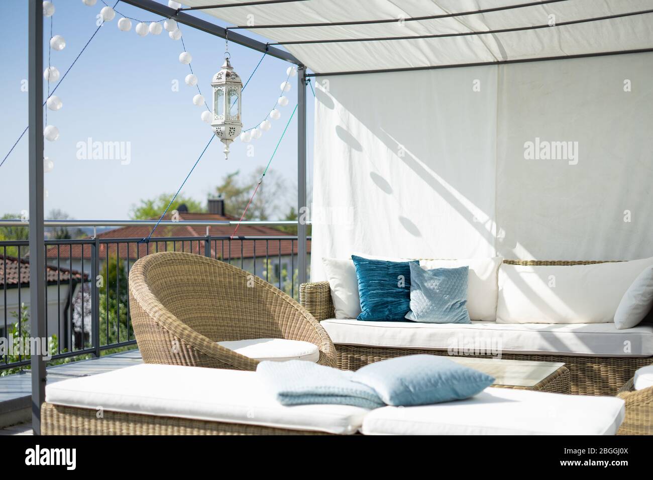 Elegant terrace with canopy and lounge furniture on a sunny morning Stock Photo