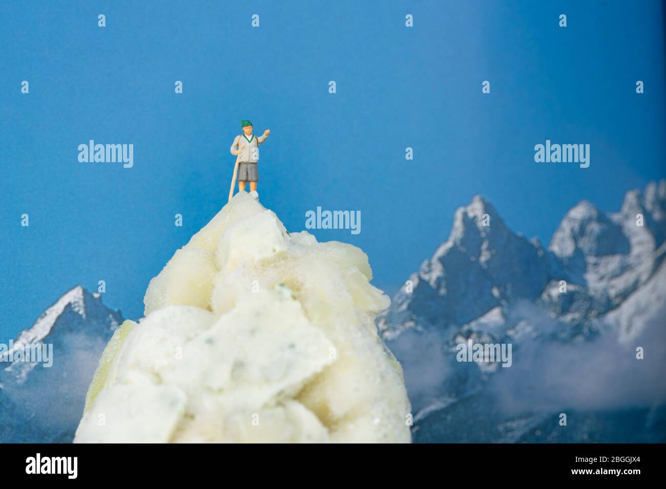 Little grandma in a folk costume has climbed the peak of a mountain of frozen cabbage Stock Photo