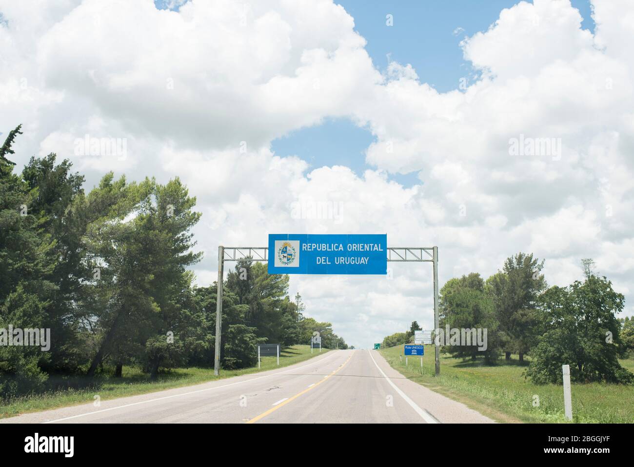 Road landscape with the entrance sign to the Oriental Republic of Uruguay, on the land border of this country with Argentina Stock Photo