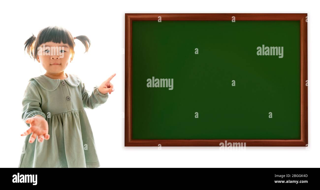 Adorable asian baby girl pointing finger on a empty board, over white background Stock Photo