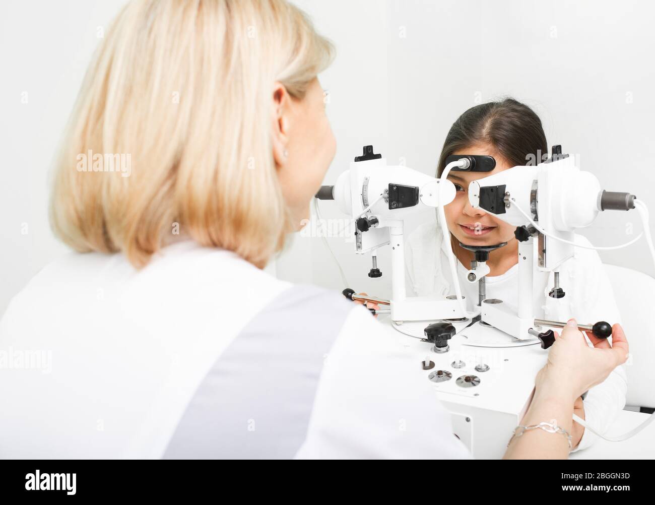 Young girl visiting ophthalmologist in clinic. Diagnosis and correction of vision in children Stock Photo