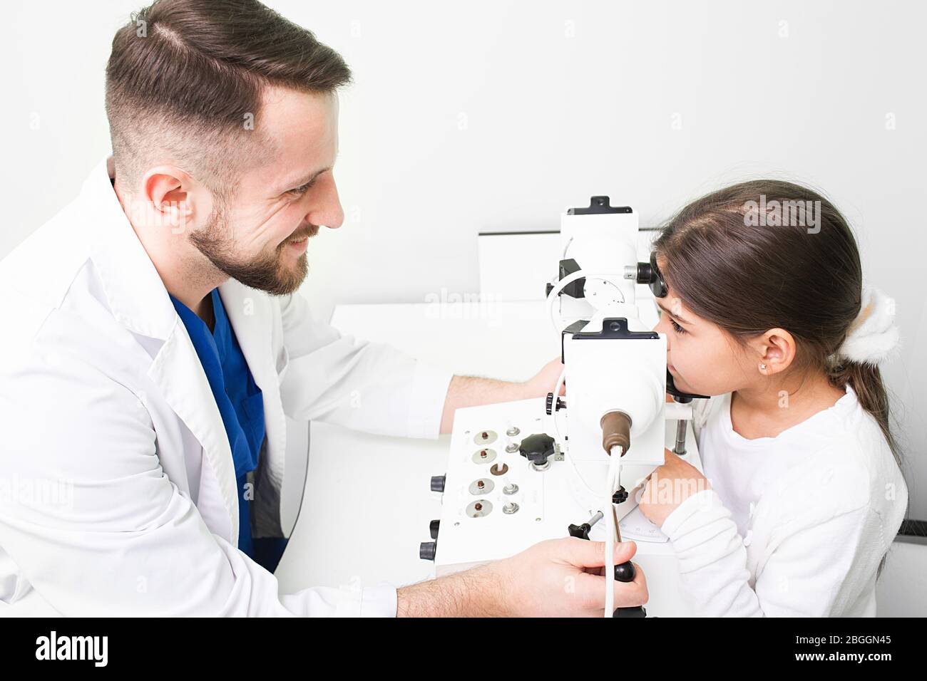 Optometrist doing strabismus checkup using synoptophore. Strabismus in children. Ophthalmic clinic Stock Photo