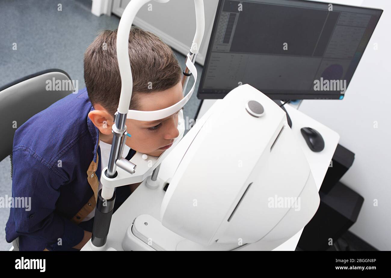 Vision correction in a boy. Super modern equipment in a modern clinic for eye examination Stock Photo