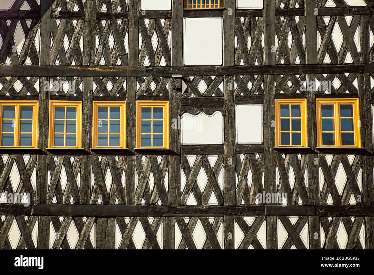 Typical German house. Walls with neat yellow windows. Details, fragment ...