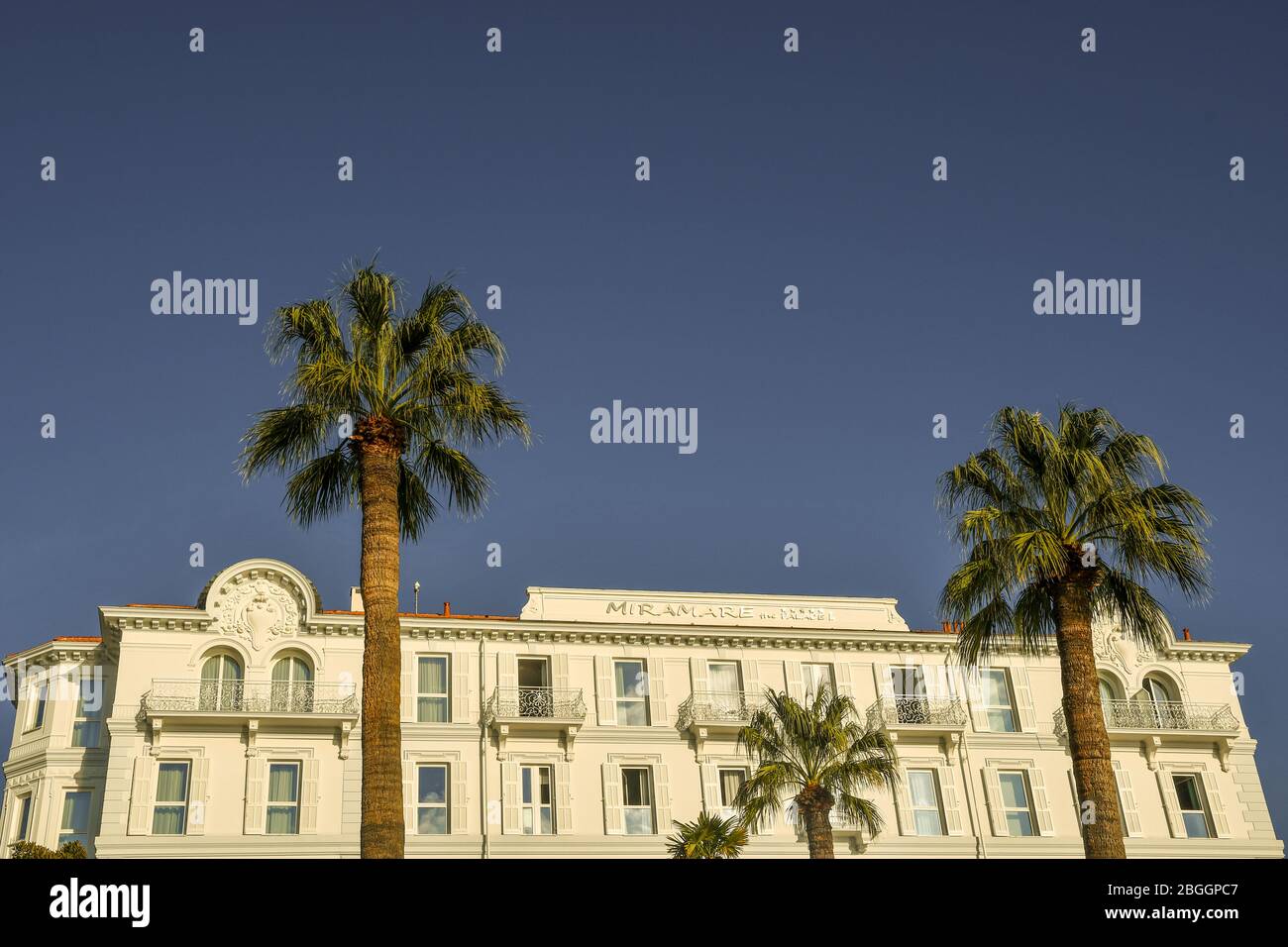 Top of the Miramare The Palace, a luxury five-star hotel on the sea shore of Sanremo in the Riviera of Flowers with palm trees, Liguria, Italy Stock Photo