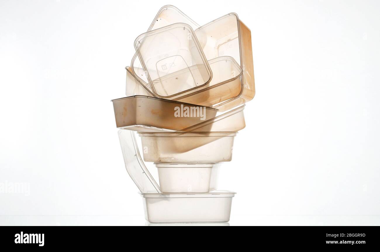 A pile of used plastic takeaway boxes on a white background Stock Photo