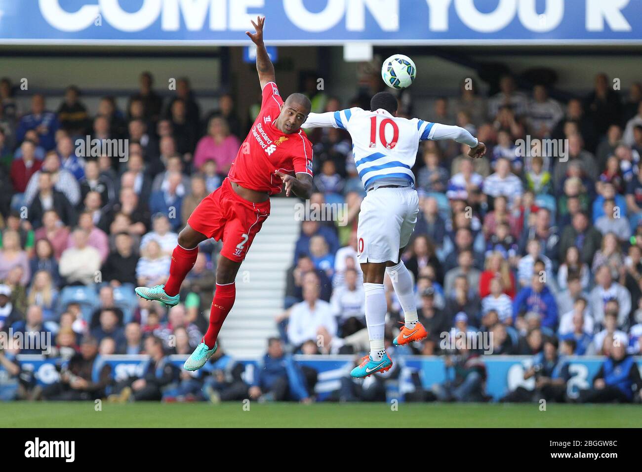 LONDON, ENGLAND.  Liverpool Defender Glen Johnson jumps with Queens Park Rangers Midfielder Leroy Fer for a header in the first half during the Barclays Premier League Match between Queens Park Rangers & Liverpool at Loftus Road, London on Sunday October 19th 2014  (Credit: MI News) Stock Photo