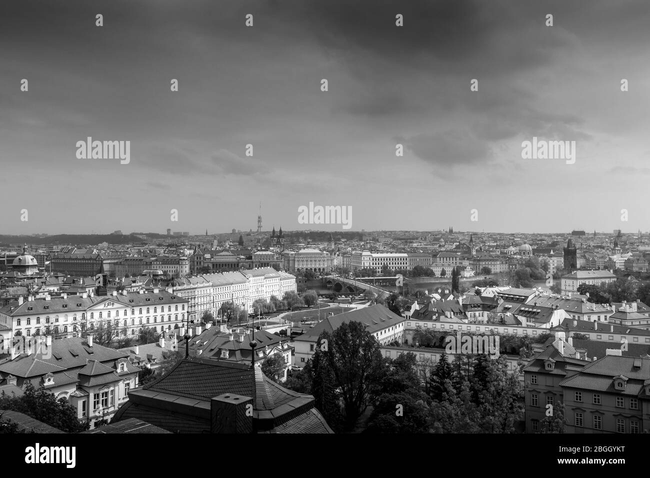 Prague cityscape panorama with red roofs roof. Street top view in a cloudy day. The capital of the Czech Republic. Black and white photo. Monochrome. Stock Photo