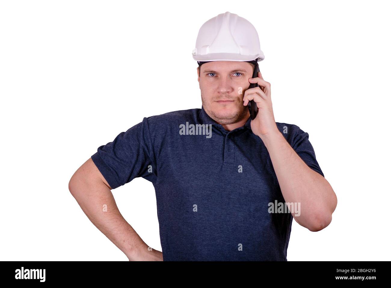 white male engineer in a white hard hat Stock Photo