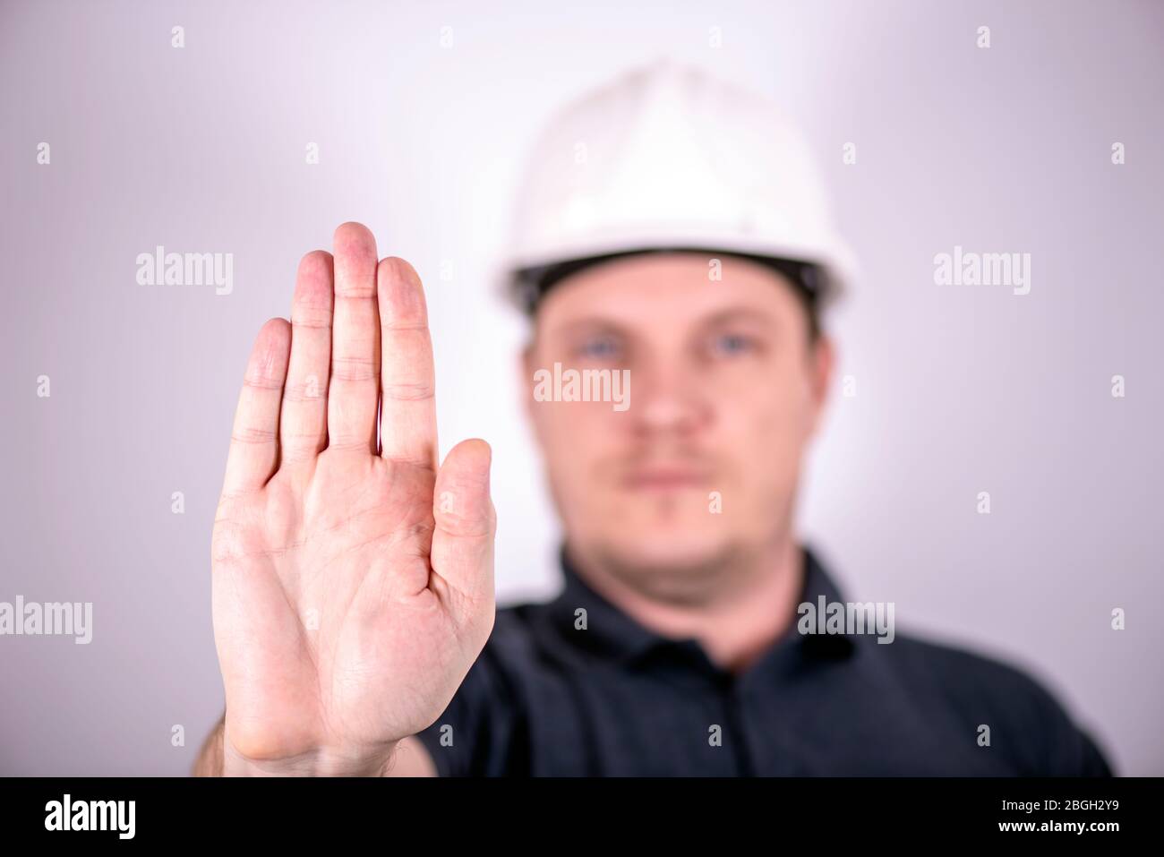 white male engineer in a white hard hat Stock Photo