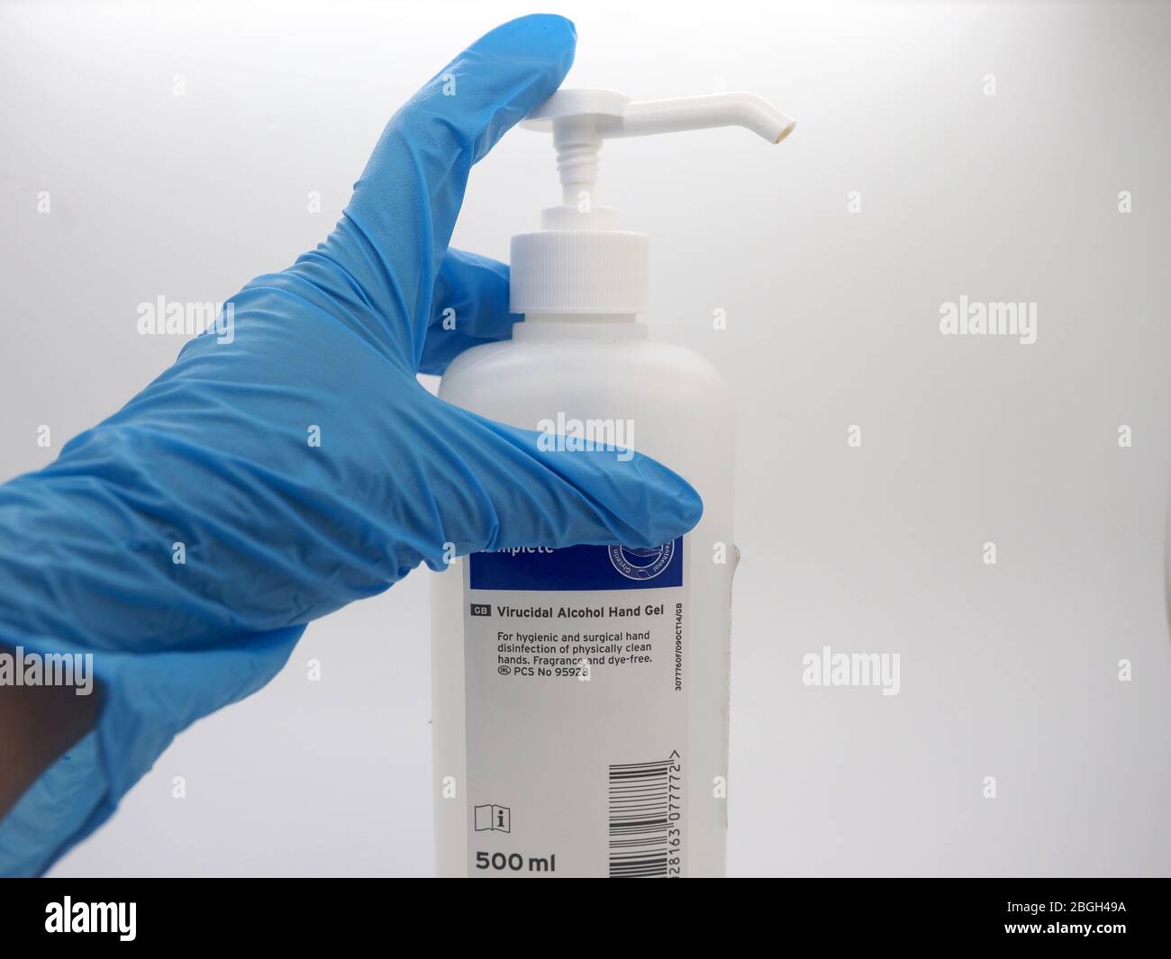 April 2020, Pair Of Hands Wearing Blue Disposable Gloves Picking Up A