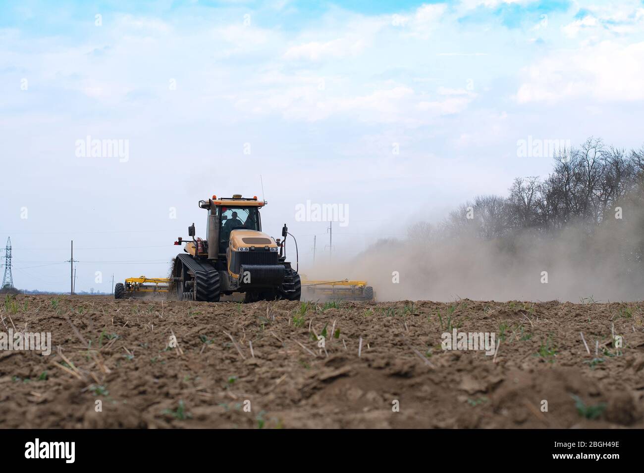 The tractor working on the field. Close up Stock Photo