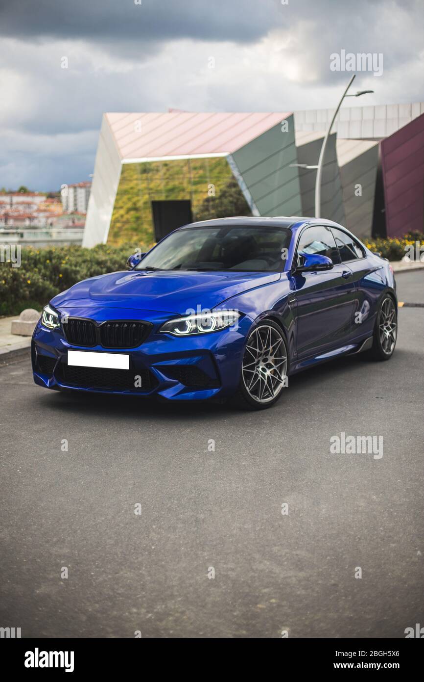 Parking blue sedan outdoor, with a panoramic buildings view Stock Photo