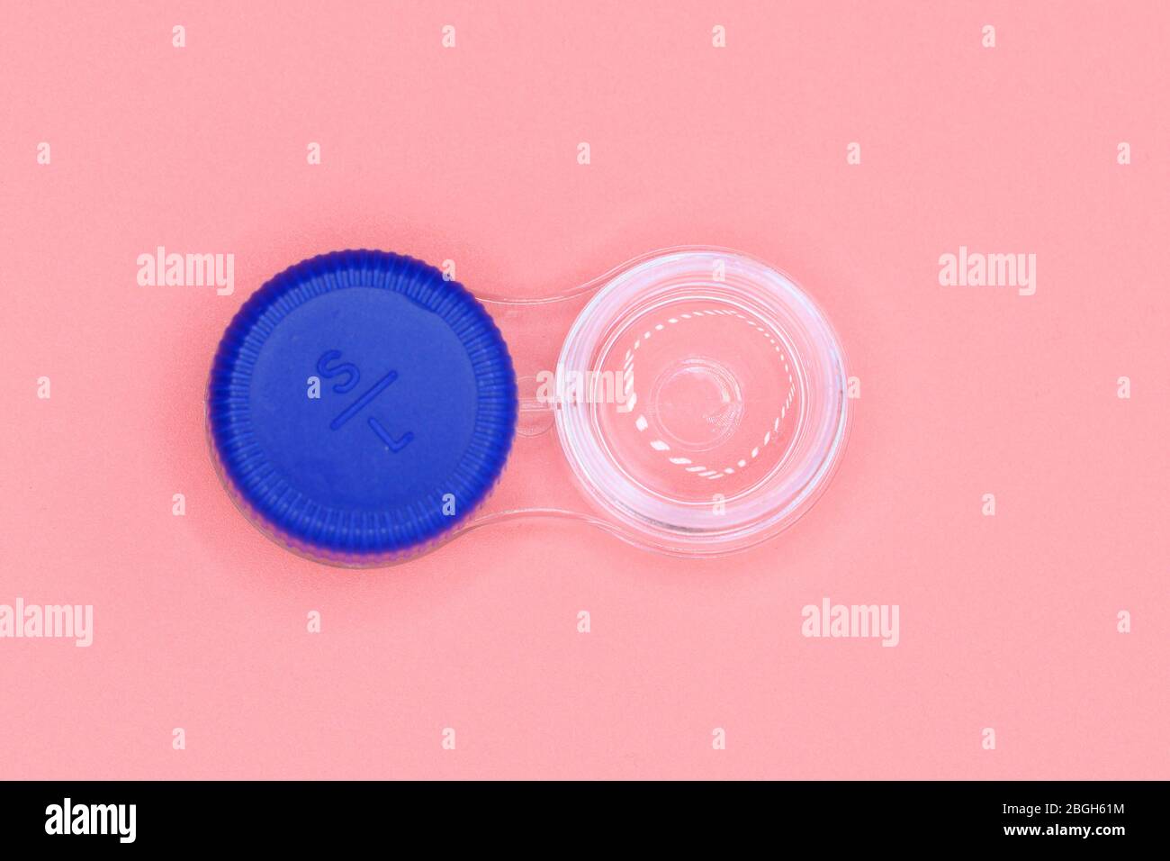 Contact lens case on pink pastel background . Stock Photo