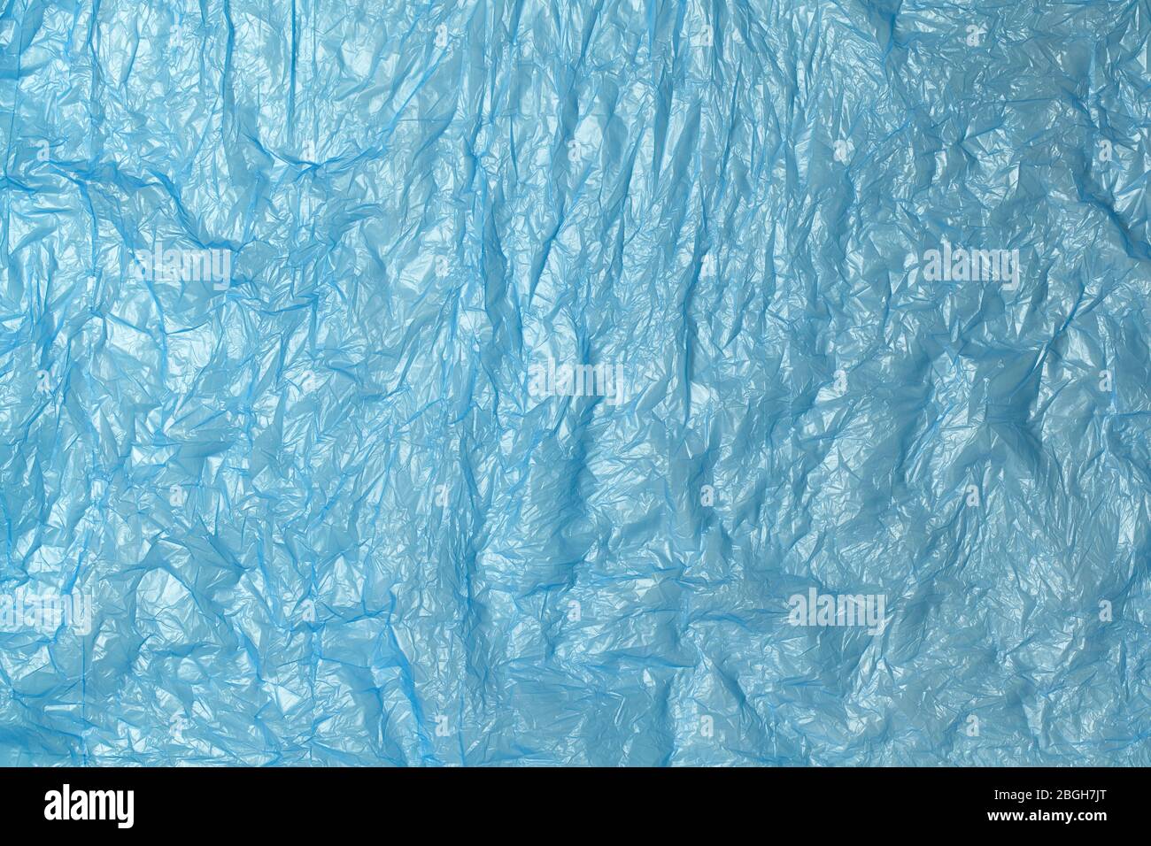 Background from blue recyclable polyethylene. Eco, zero waste, alternative to plastic concept. Flat lay. Horizontal. Close-up. Stock Photo