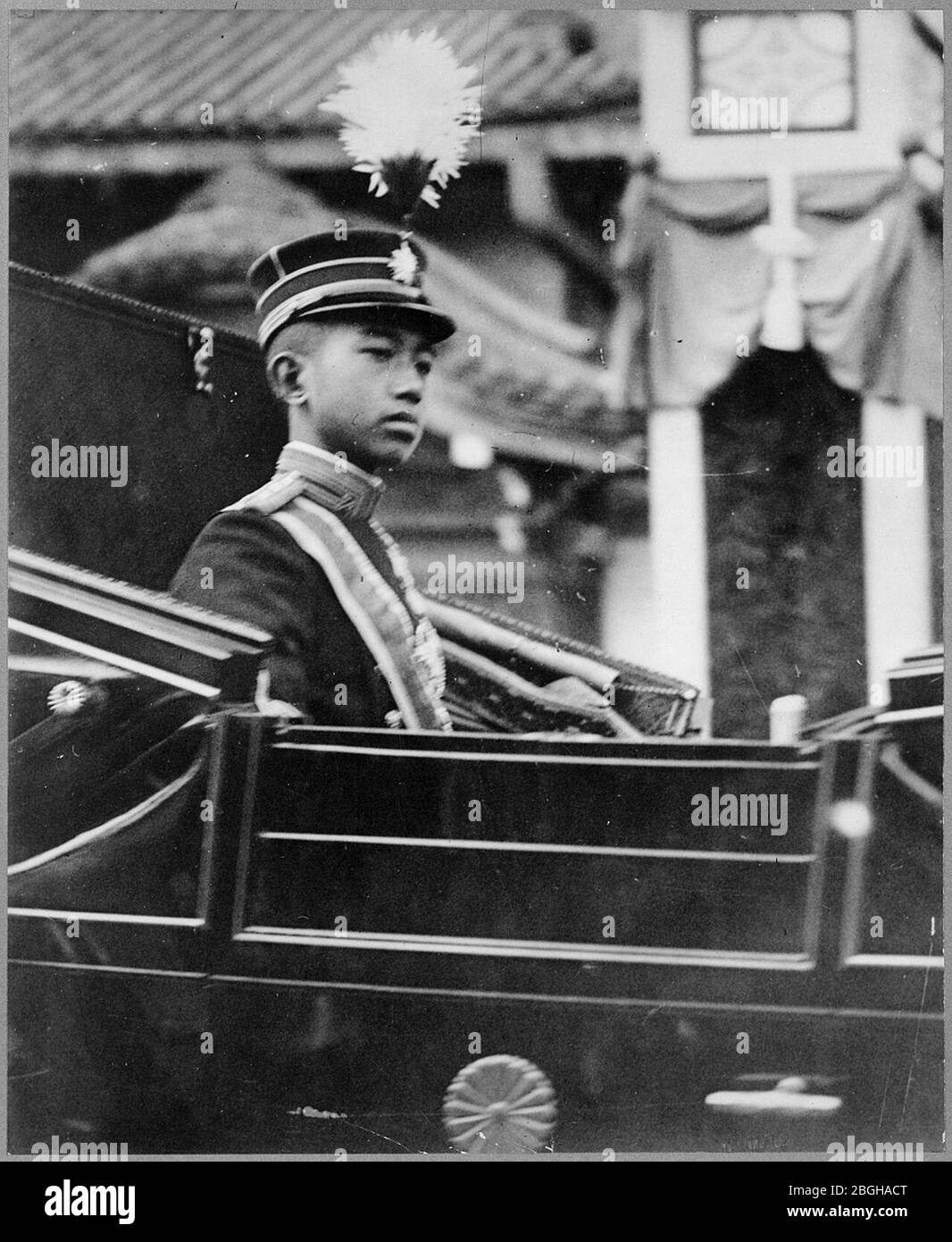 Hirohito, Emperor of Japan, half-length portrait, facing right, seated in carriage with chrysanthemum emblem on the door. Stock Photo