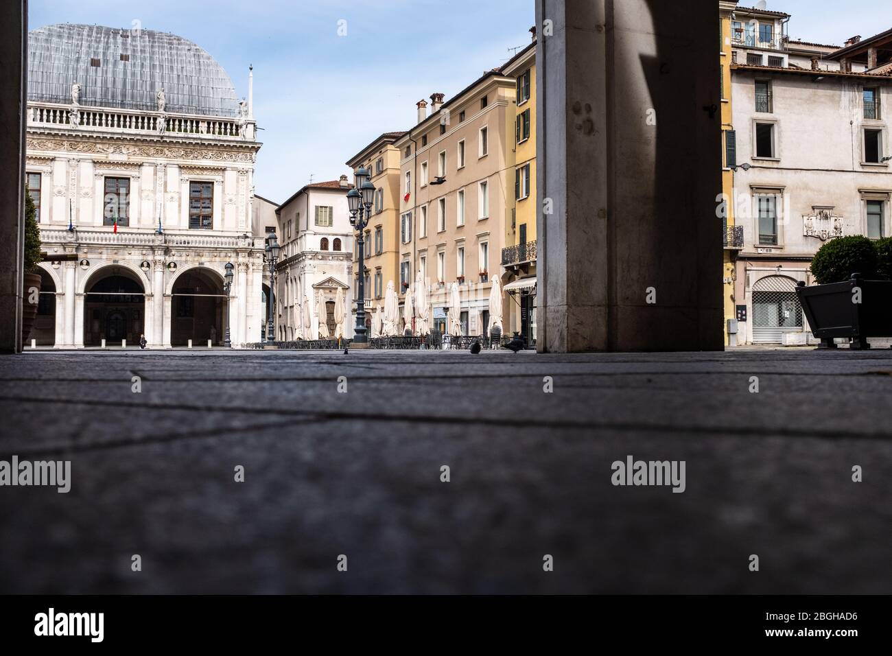 Street-level view of an unusually empty Italian square on Saturday morning: Brescia streets are deserted as the entire country is lockdown. Stock Photo