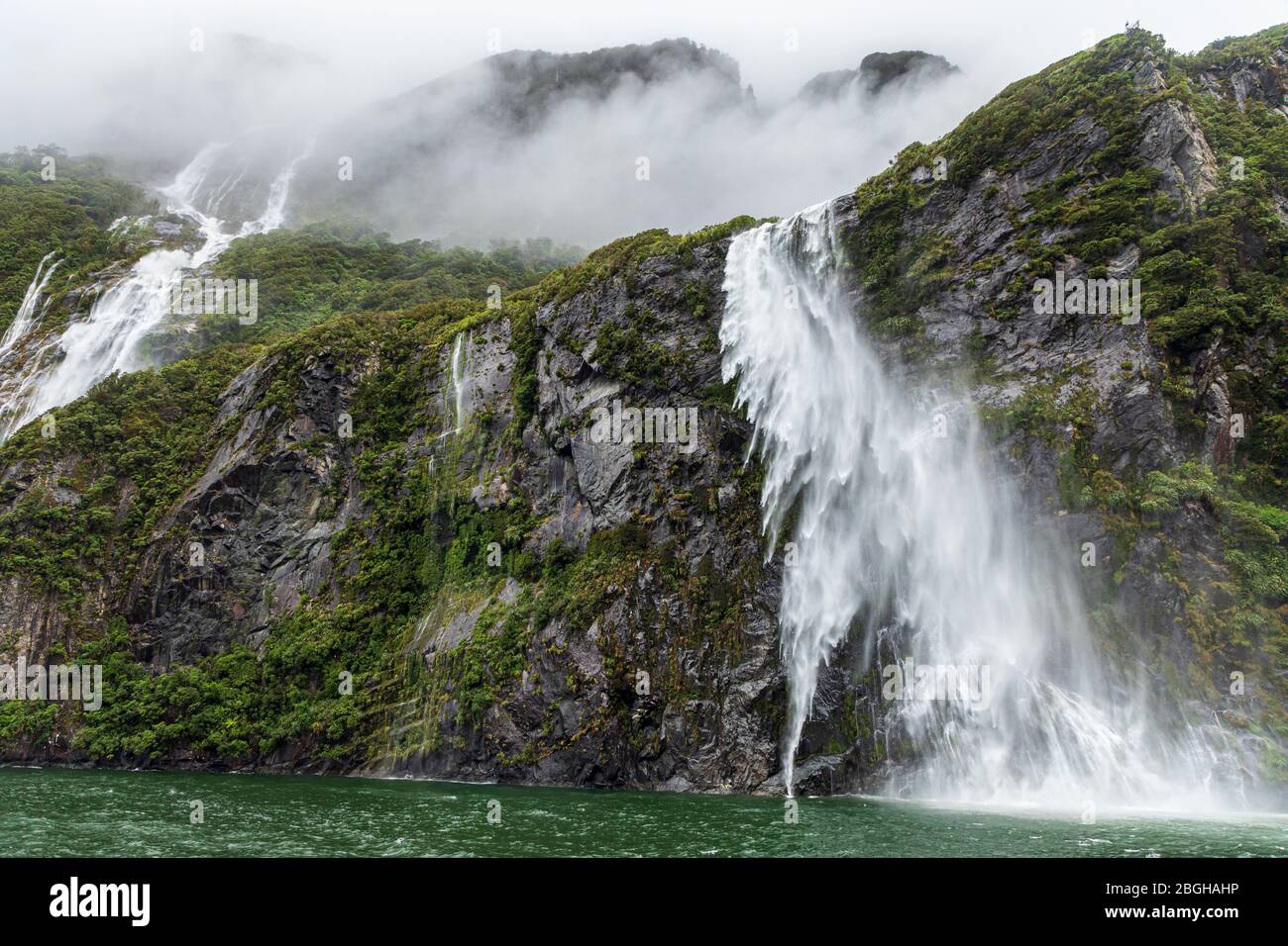 Stirling Falls being blown by the wind on a stormy day, Milford Sound, Fiordland National Park, South Island, New Zealand Stock Photo