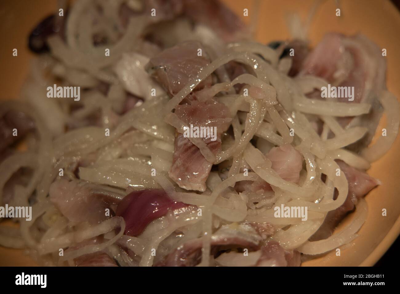 Peeled and chopped slightly salted Pacific herring with onion. Natural