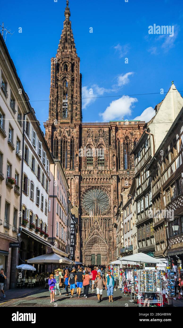 souvenir stalls in Rue Mercière against the backdrop of Strasbourg Cathedral's west façade, Strasbourg, Alsace, France Stock Photo