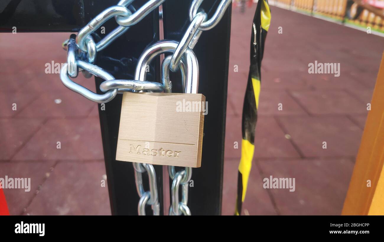 empty children playground door locked with chain and lock  due to covid-19 coronavirus pandemic quarantine measures. Igoumenitsa Greece Stock Photo