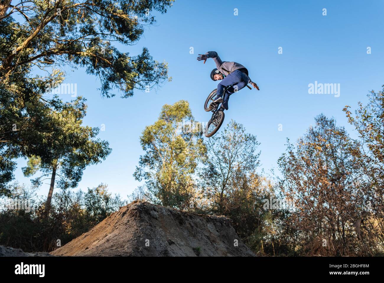 BMX Bike jump over a dirt trail on a 