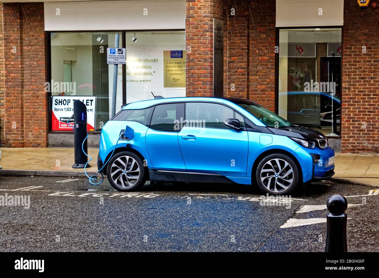 Kingston upon Thames, London / UK - May 8 2019: A BMW i3 Hatchback all electric vehicle plugged into an electric charging point Stock Photo