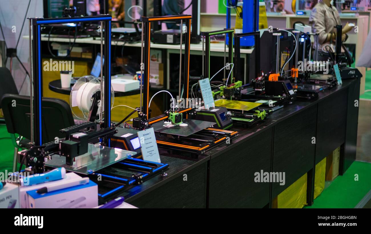 MOSCOW, RUSSIA - OCTOBER 12, 2018: 3D Print Expo - automatic 3D printers in row working at modern technology exhibition. 3D printing, additive technol Stock Photo