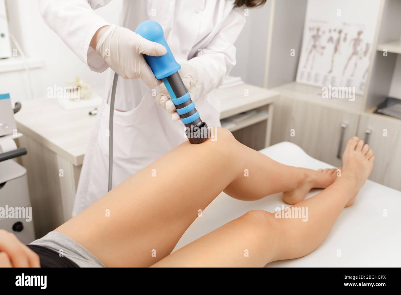 Extracorporeal Shockwave Therapy ESWT. Effective non-surgical treatment for pain. Physical therapy of knee with shock waves.Pain relief, normalization Stock Photo