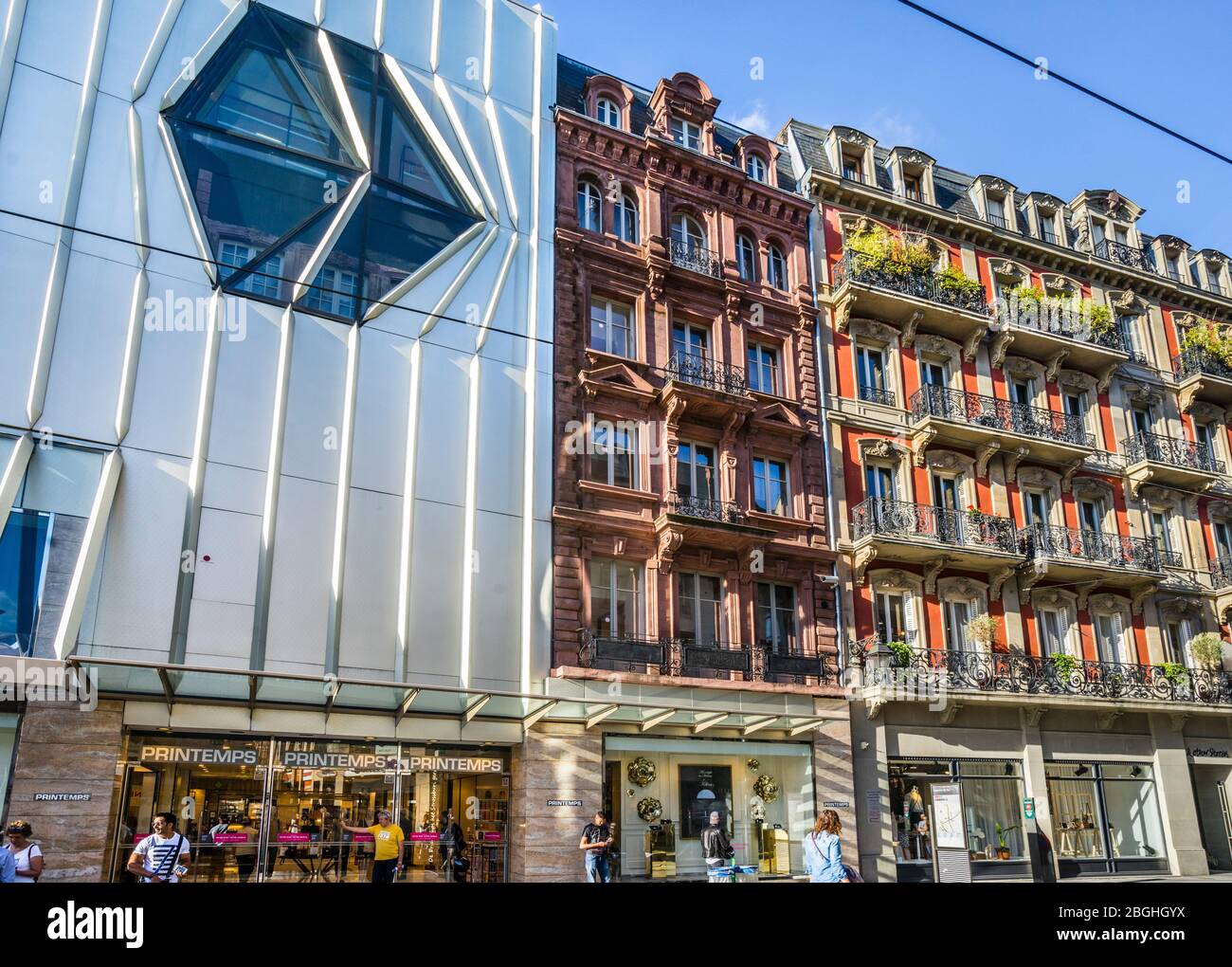 architectural contrasts in Rue de la Haute Monté in the city centre of Strasbourg, contempory department store facade next to 19th urban century resid Stock Photo