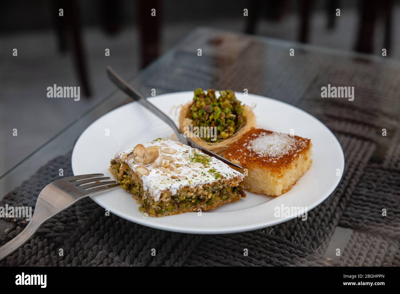 tasty arabic sweet dessert with pistachios on white plate in typical