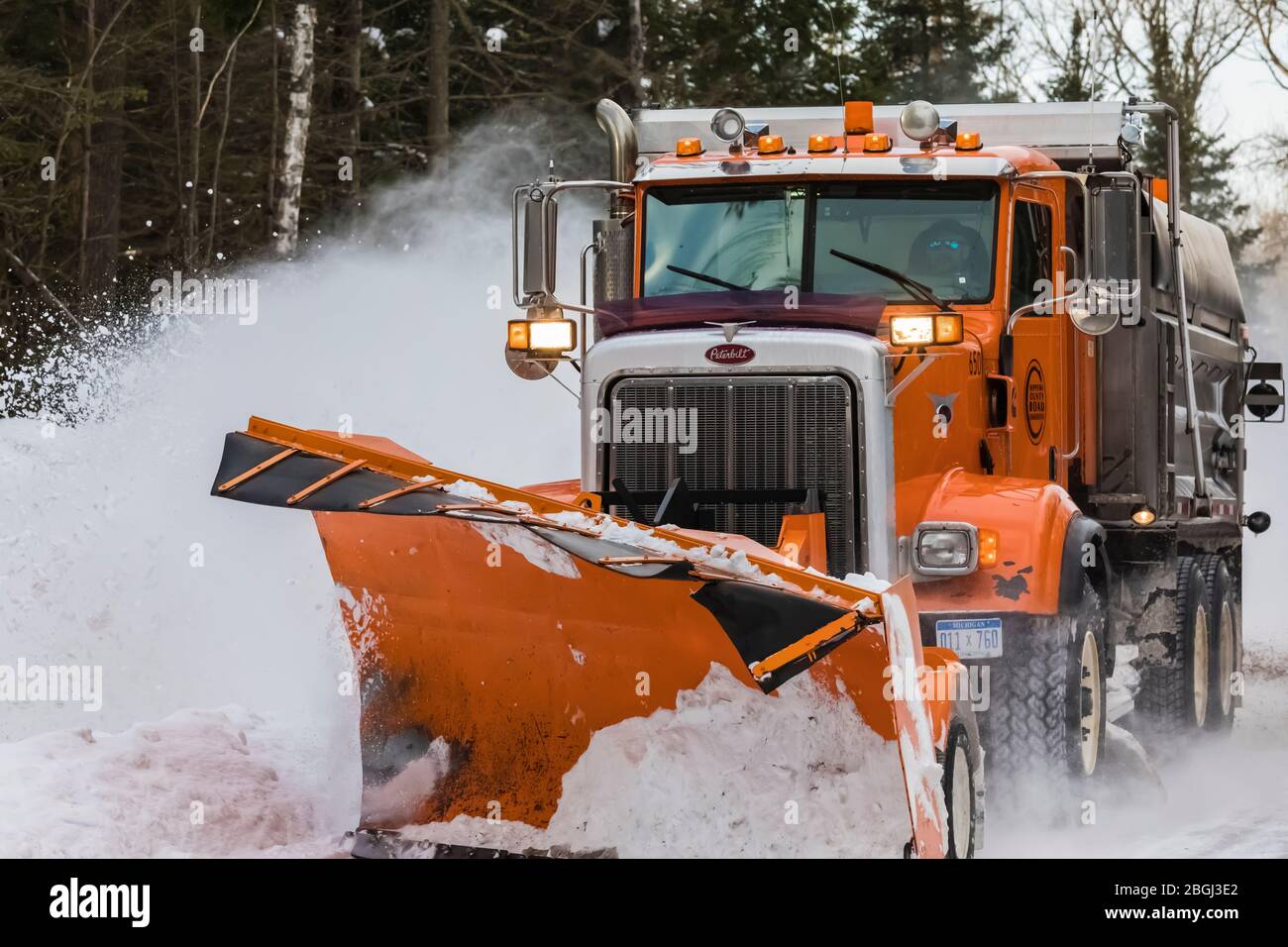Snow plow on a remote road in the eastern Upper Peninsula, Michigan
