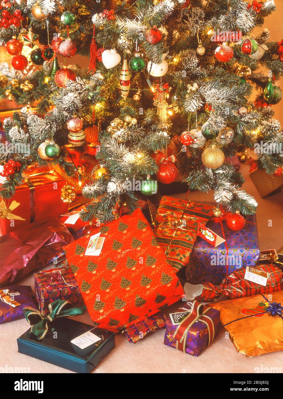 Christmas presents underneath Christmas tree, Ascot, Berkshire, United Kingdom Stock Photo