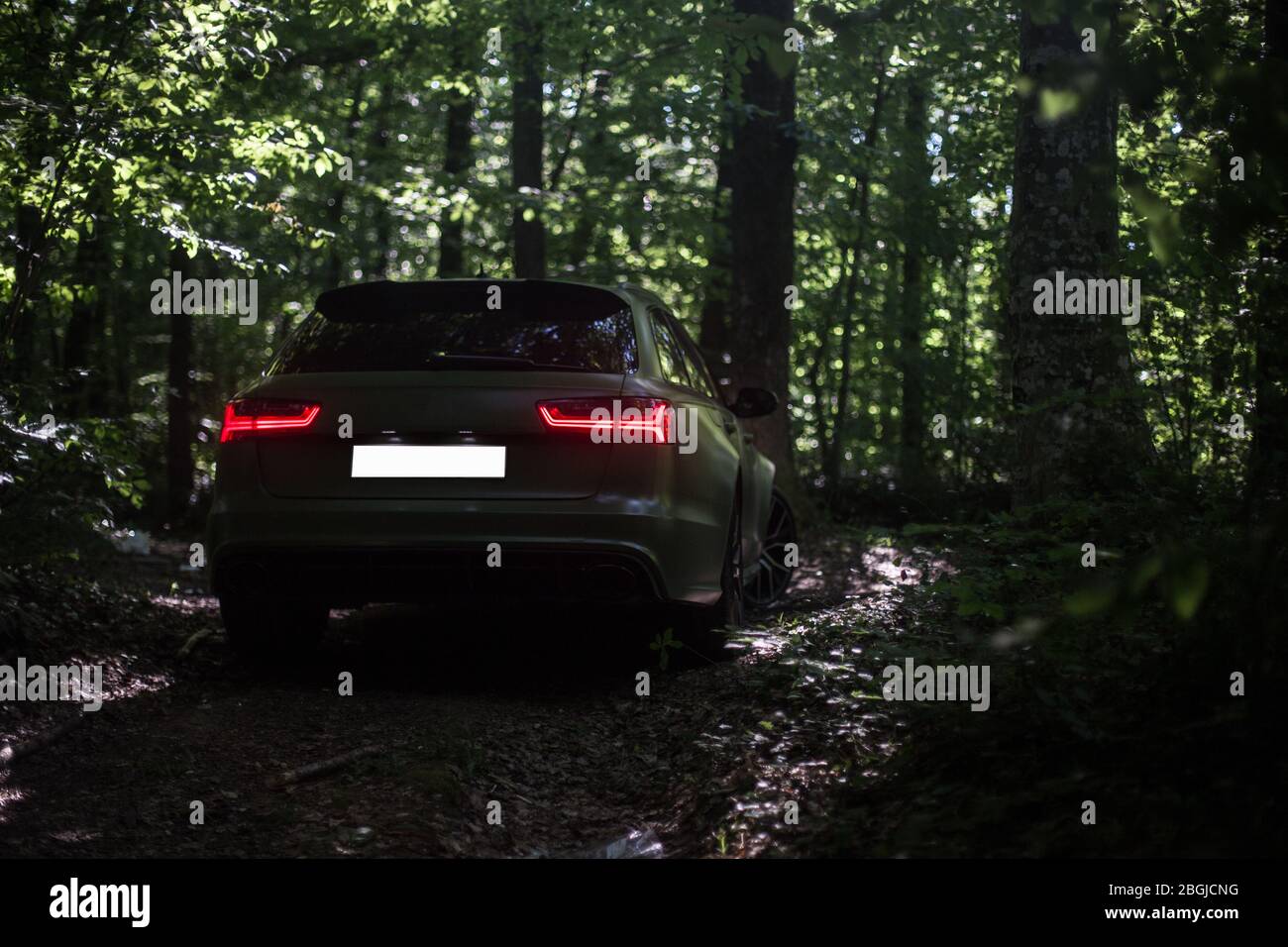 Parking a black sedan in the forest , escaped and hiding, view from ...