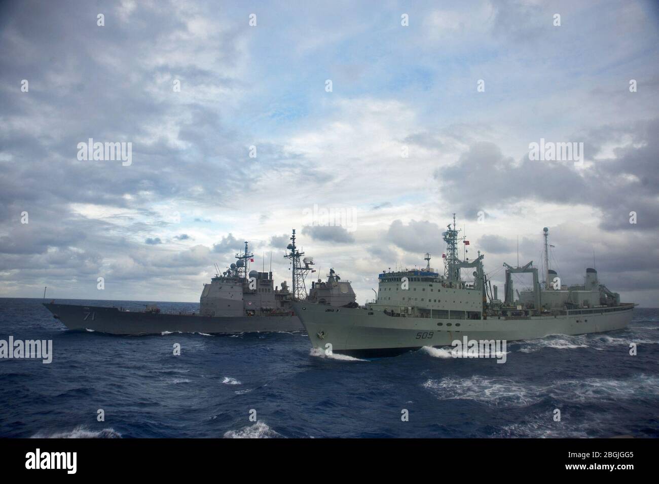 HMCS Protecteur (AOR 509) refuels USS Cape St.George (CG-71) in 2014. Stock Photo